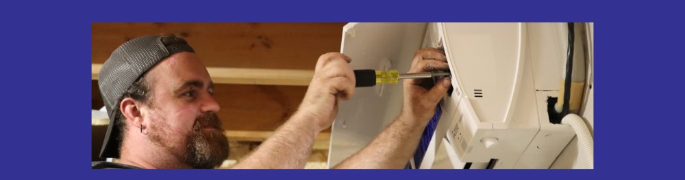 A Cross technician works on a ductless AC unit. Introduces the section of the blog about ductless air conditioners.