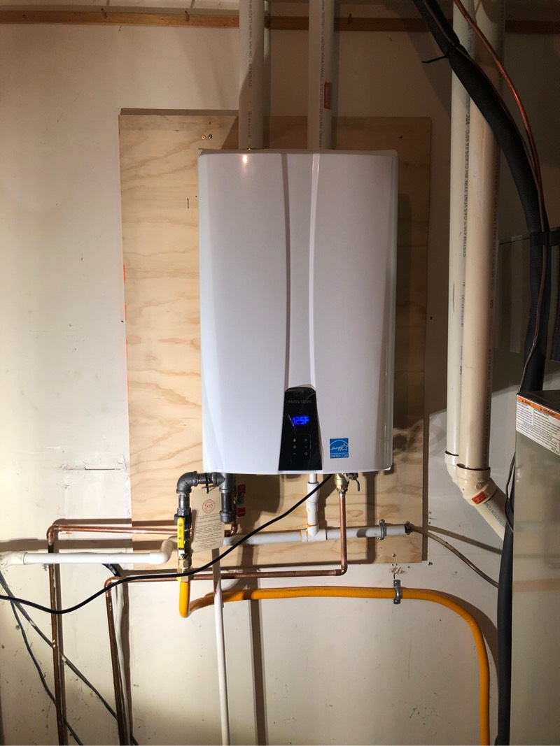 Tankless Water Heater mounted on wall in basement