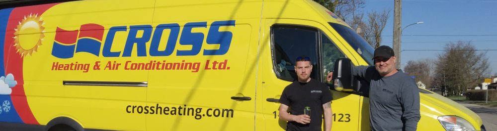Cross Heating Technicians standing in front of their branded van.